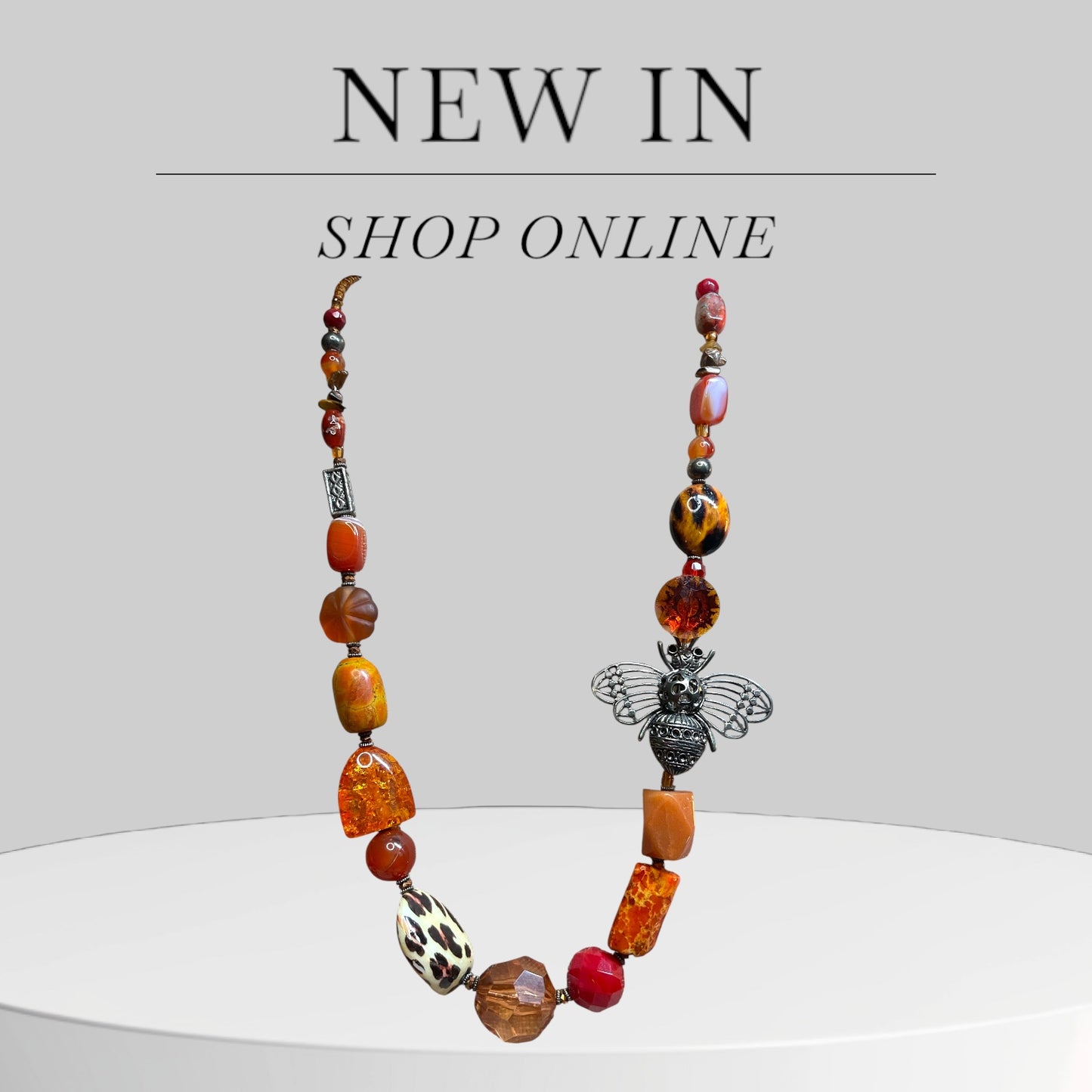Orange and Amber beaded necklace with a bee pendant