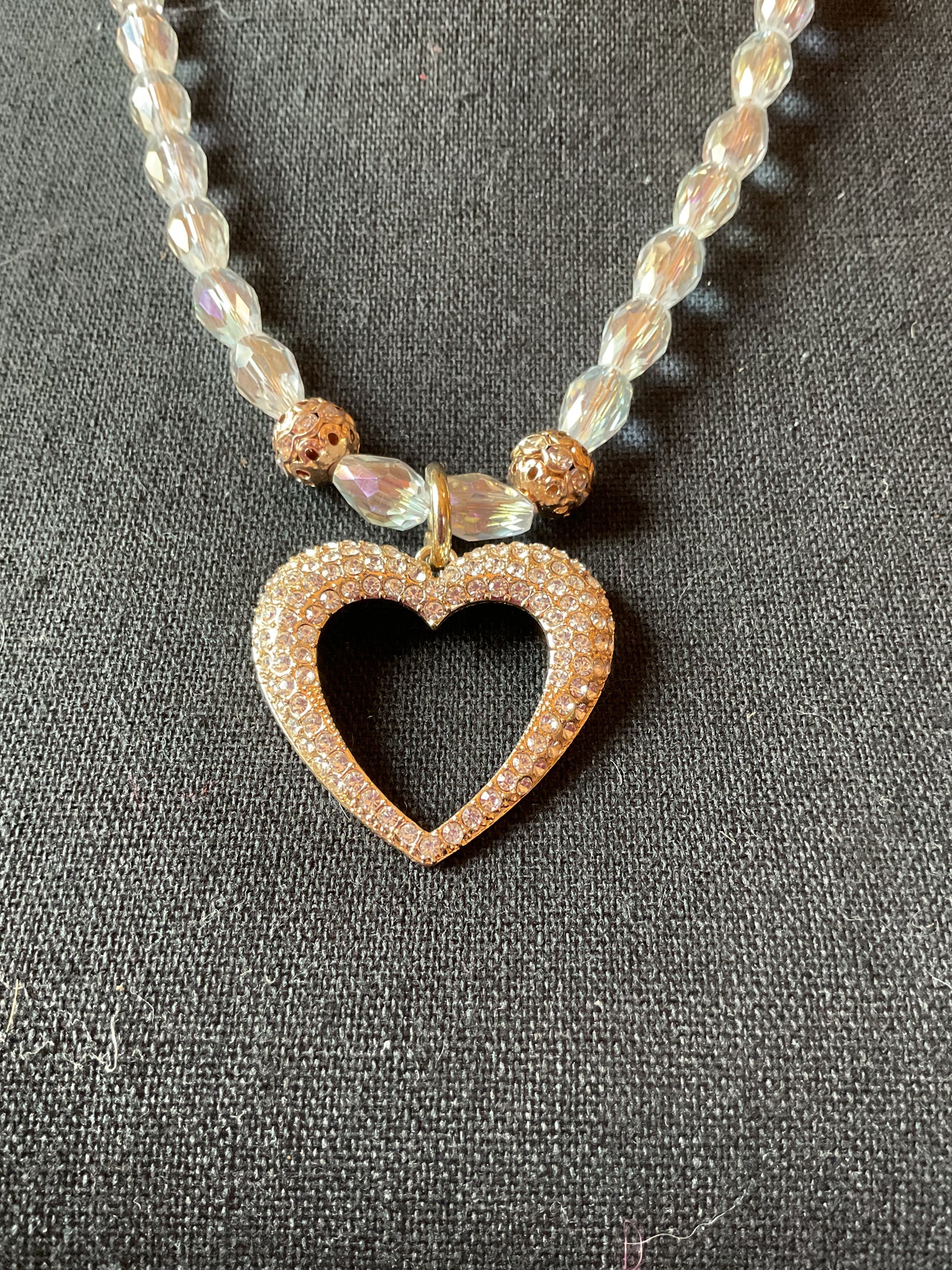 Rhinestone heart pendant strung on clear crystal beads