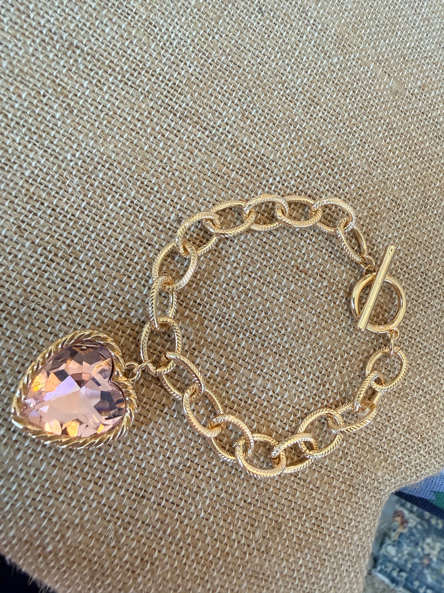 Gold tone chain bracelet with beautiful pink glass stone heart