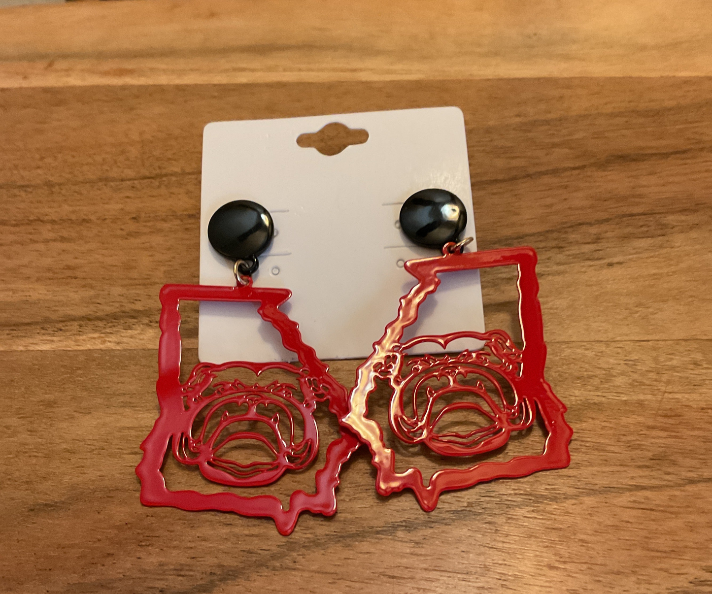 Stylish red earrings featuring a bulldog design.