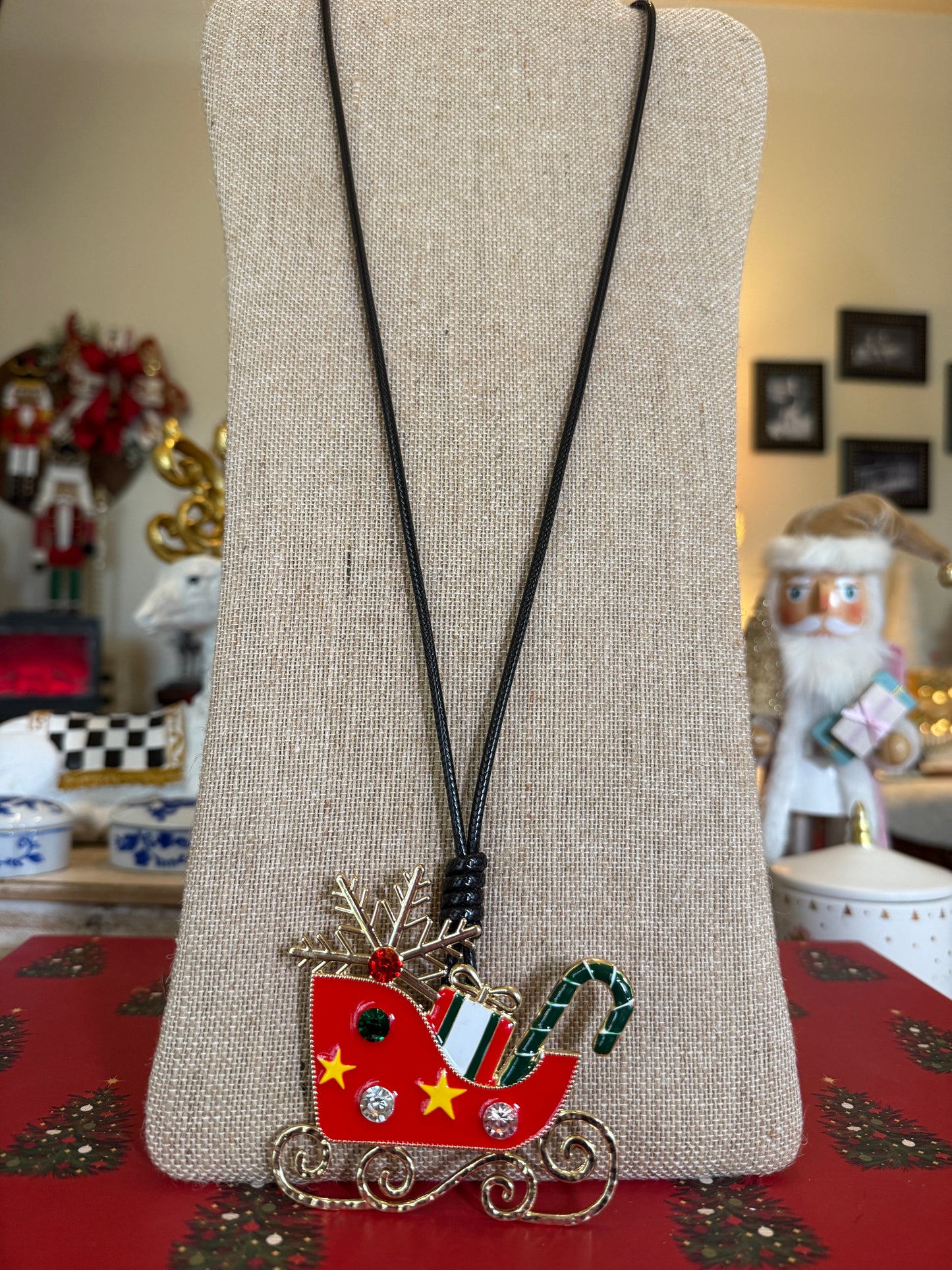 Large Sleigh pendant on a black cord necklace