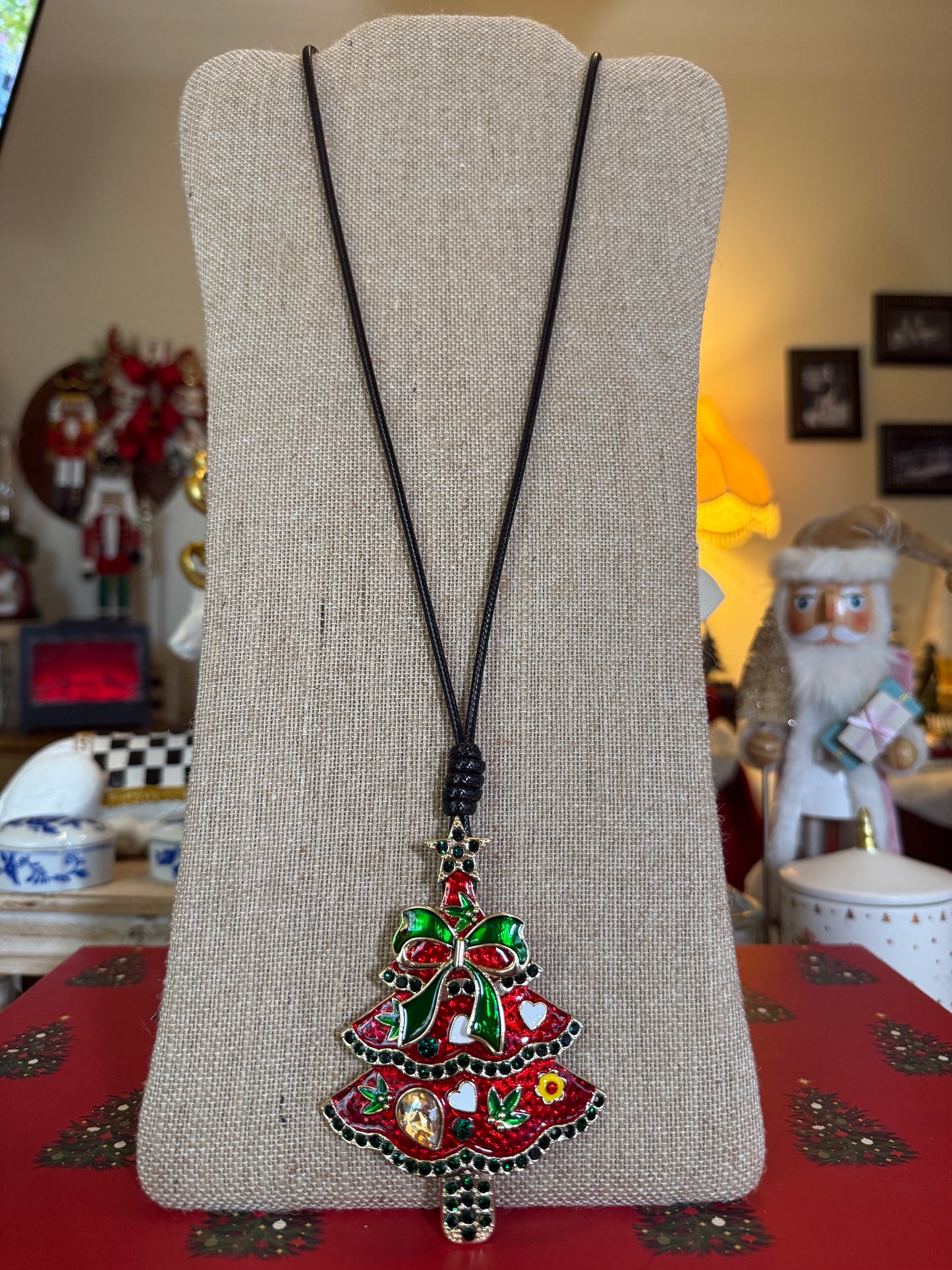 Large red Christmas tree pendant on a black cord necklace