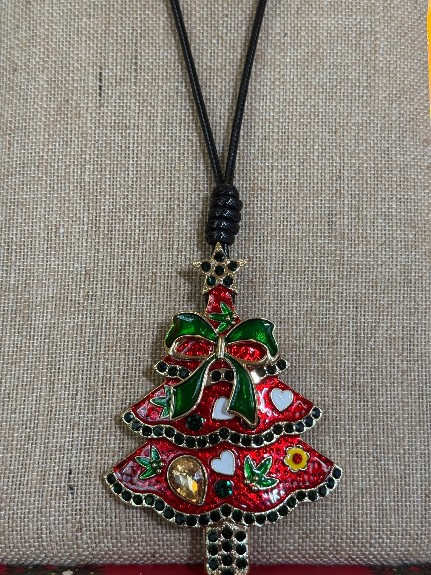 Large red Christmas tree pendant on a black cord necklace