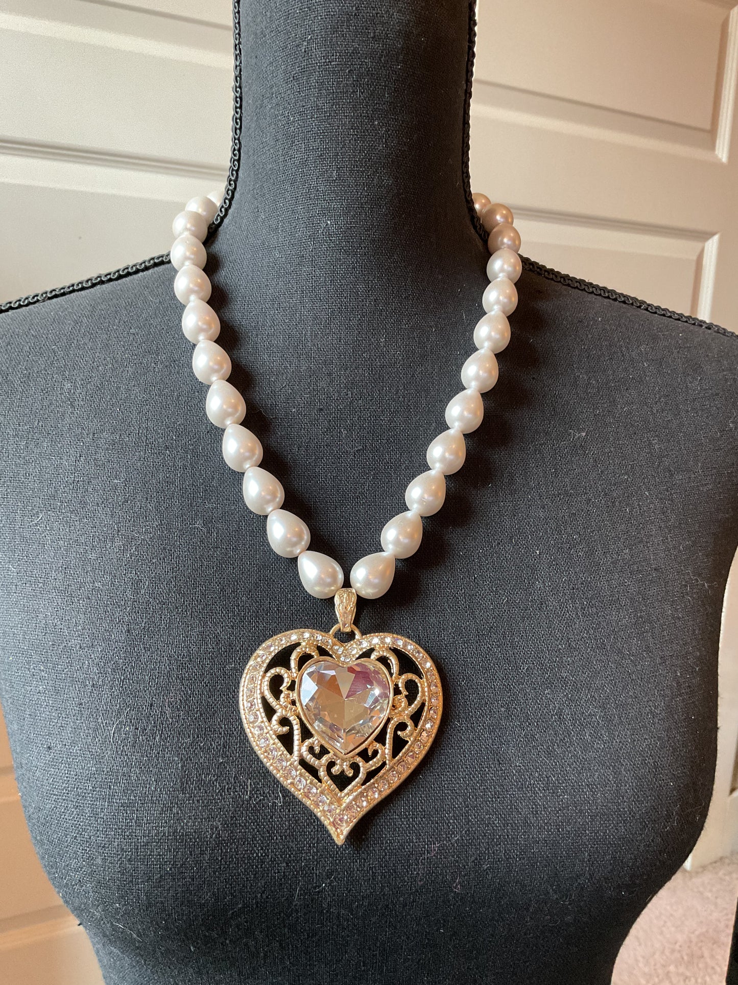 Large gold tone heart with beautiful clear stone pendant on pearls