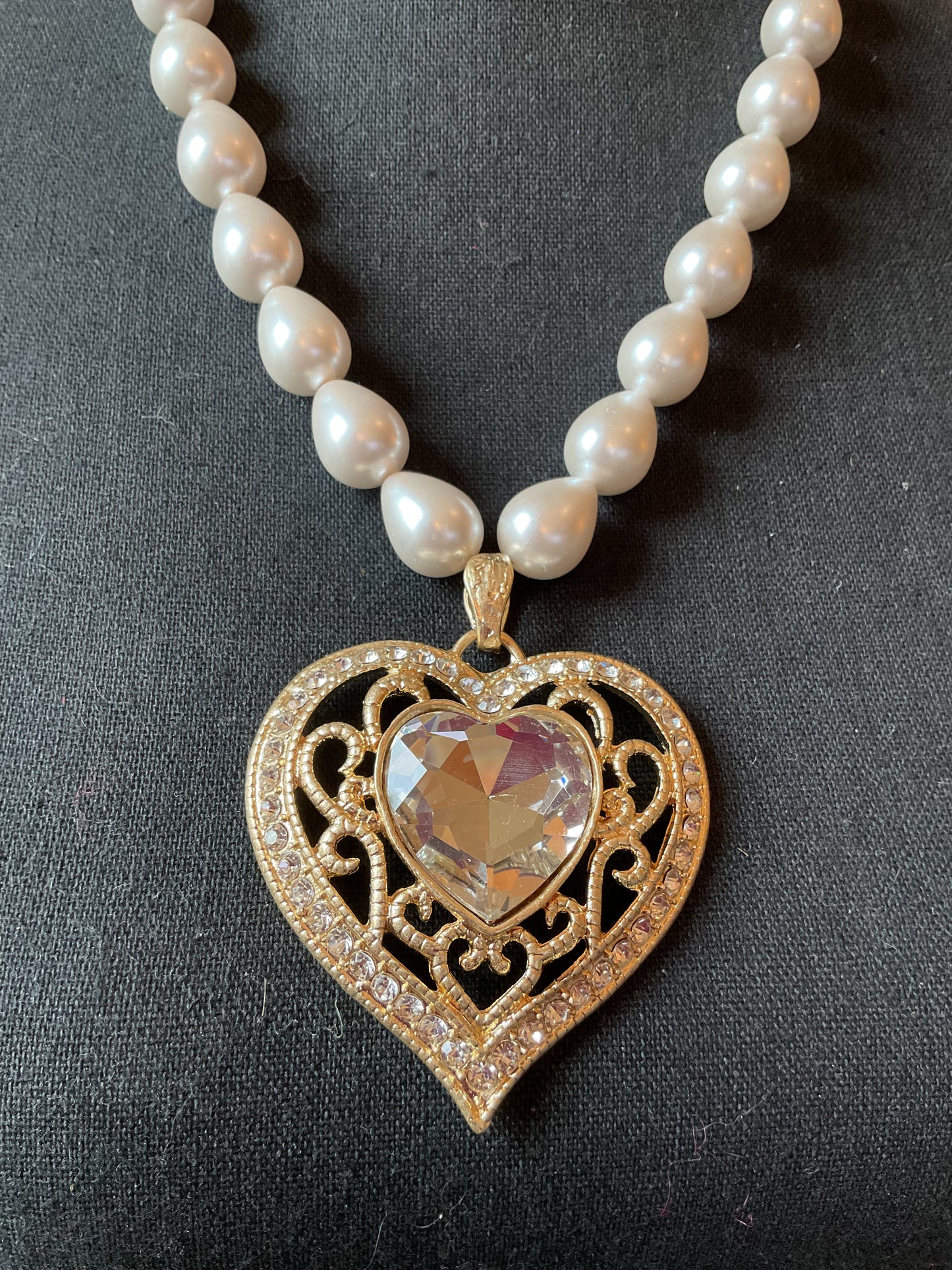 Large gold tone heart with beautiful clear stone pendant on pearls