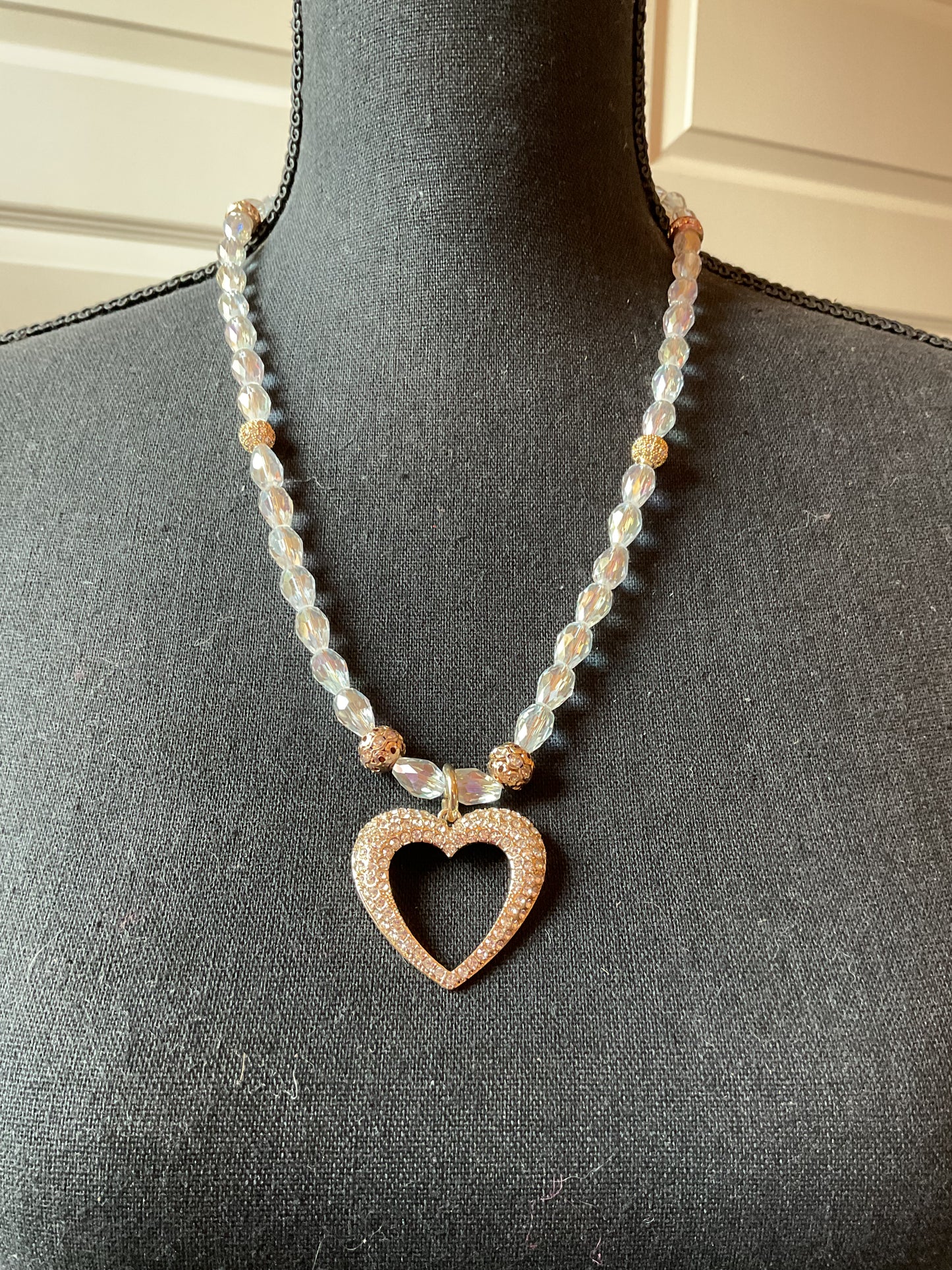 Rhinestone heart pendant strung on clear crystal beads