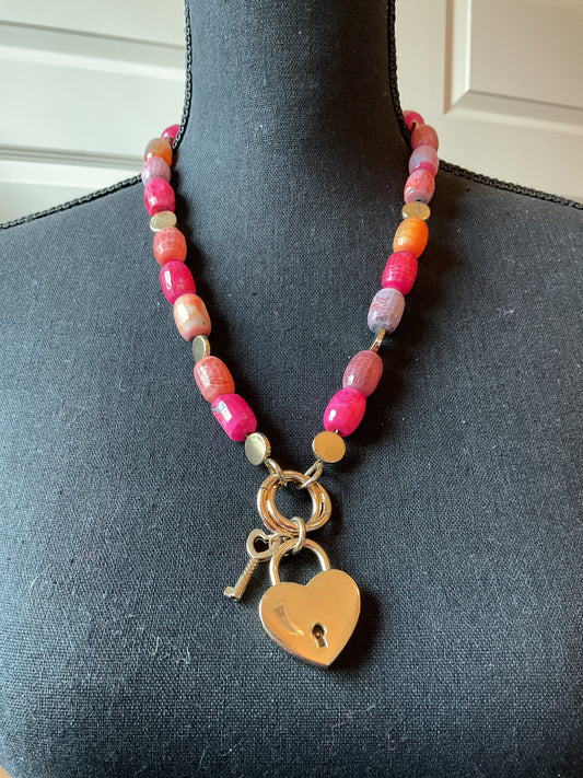 Multi color beaded necklace with gold tone heart locket pendant