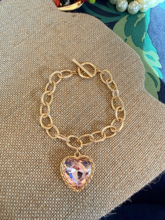 Gold tone chain bracelet with beautiful pink glass stone heart