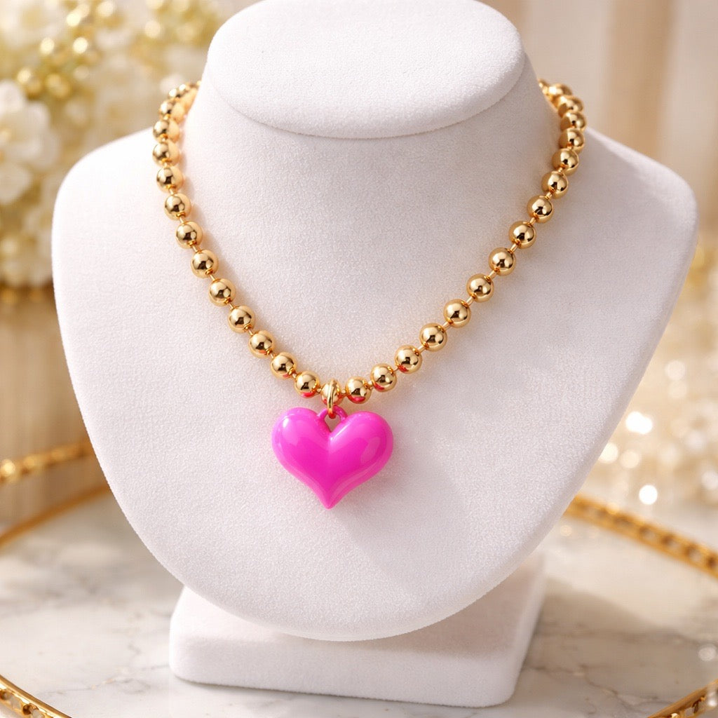 Gold tone ball chain necklace with bright pink puffy heart pendant
