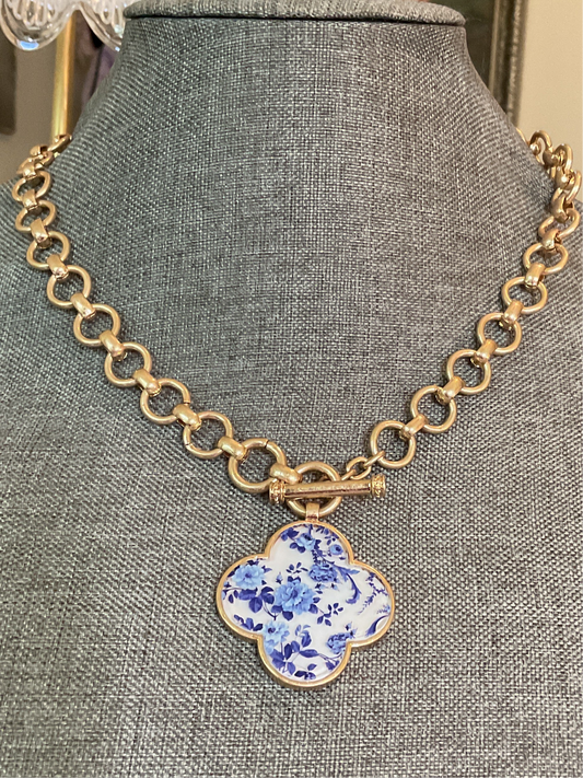 Gold chain with blue and white clover pendant