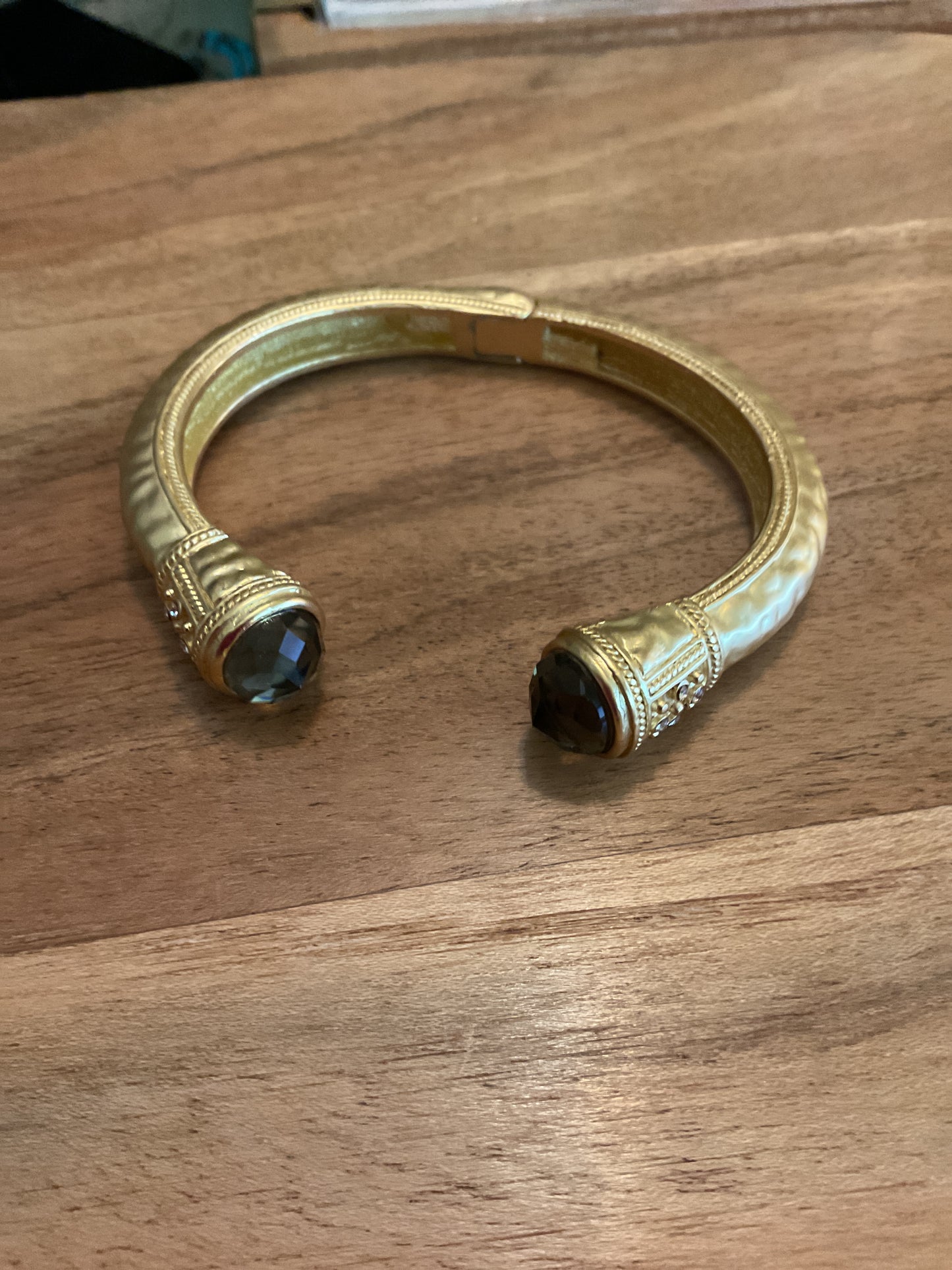 Gold cuff bracelet with black crystal accents