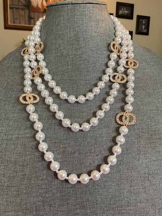 Multi layer pearl necklace with small rhinestone circle accents