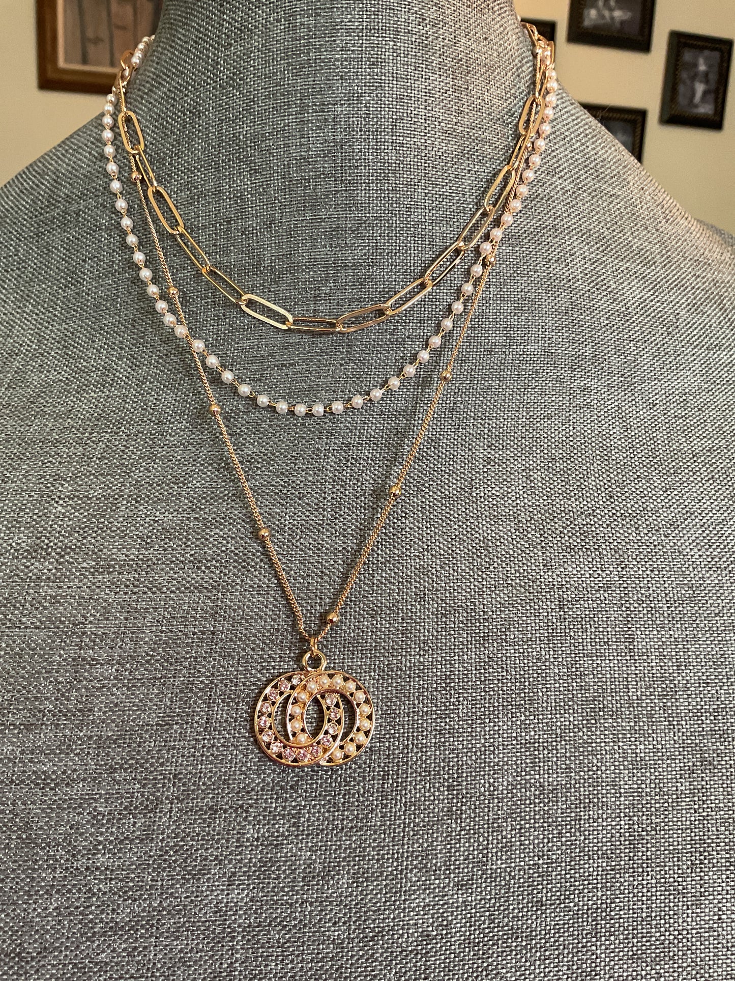 Multi layer necklace with interlocking circle, pendant and dainty pearls
