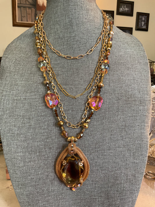 Multi layer fall color bead necklace with gold chains and a vintage pendant